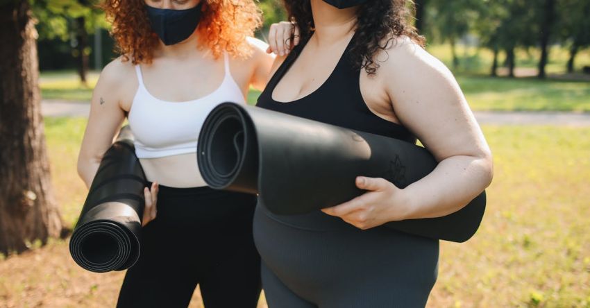 Outdoor Living - Girls Holding Rolled Yoga Mats