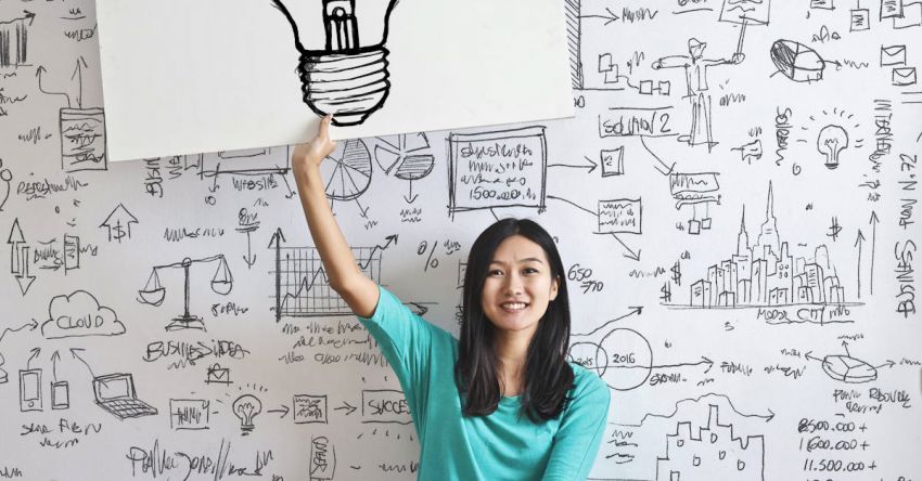 Lighting Ideas - Woman Draw a Light bulb in White Board