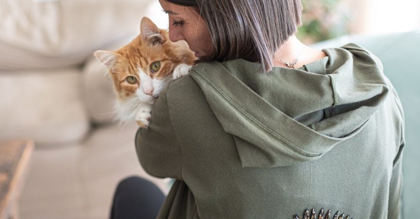 Home Hubs - A woman holding a cat in her arms while wearing an eye patch